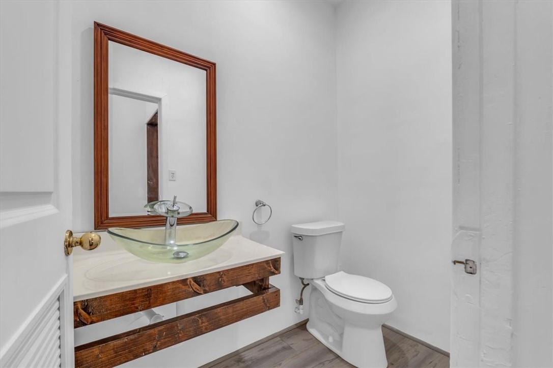 2700 Pine Avenue Waco, TX 76708 - Photo 22 of 29 a bathroom with a toilet sink and mirror
