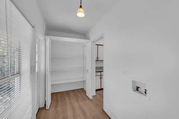 a view of walk in closet with empty racks