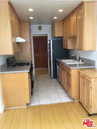 a kitchen with a sink a refrigerator and a stove