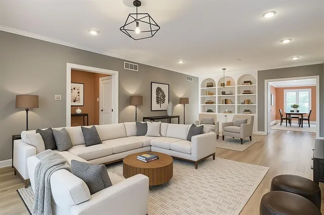 a living room with furniture and a wooden floor
