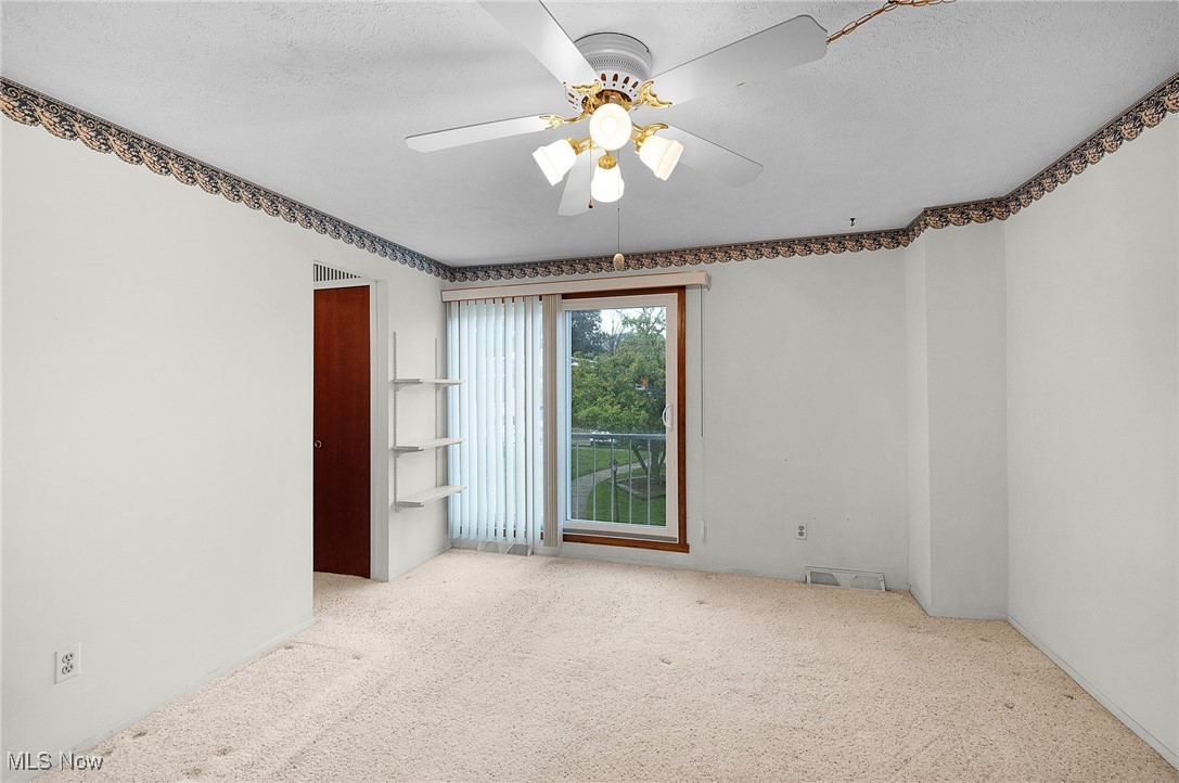 6474 State Road, Unit I10 Parma, OH 44134 - Photo 16 of 31 Empty room featuring carpet flooring, a ceiling fan, and a textured ceiling