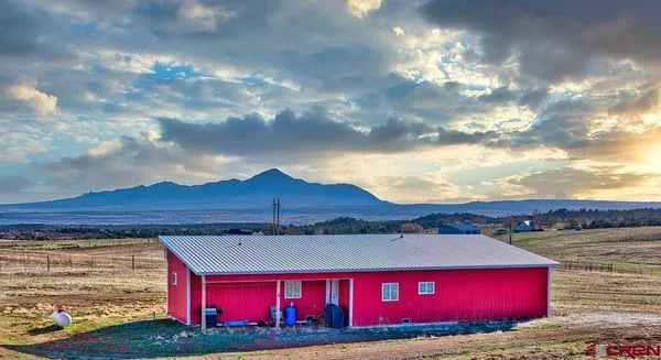 a view of a red house with a yard