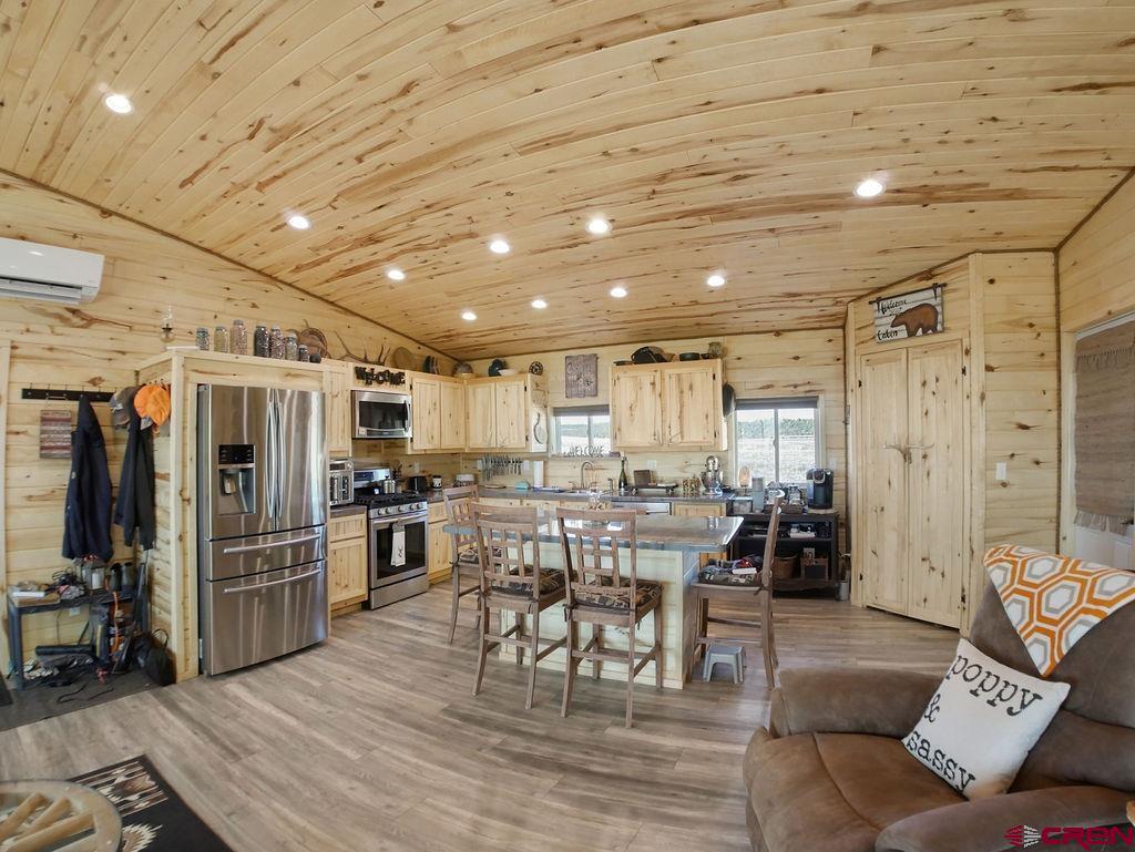 29200 Rd T.5 Dolores, CO 81323 - Photo 14 of 27 a living room with lots of wooden furniture and stainless steel appliances