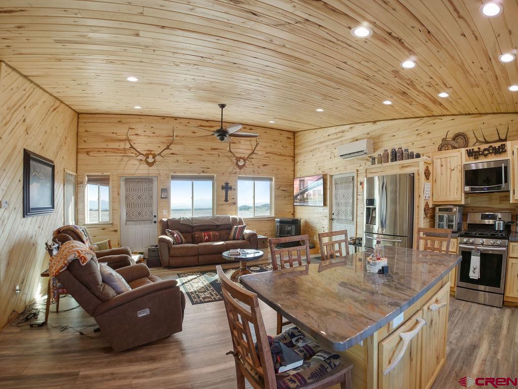 29200 Rd T.5 Dolores, CO 81323 - Photo 18 of 27 a living room with furniture a flat screen tv and kitchen view