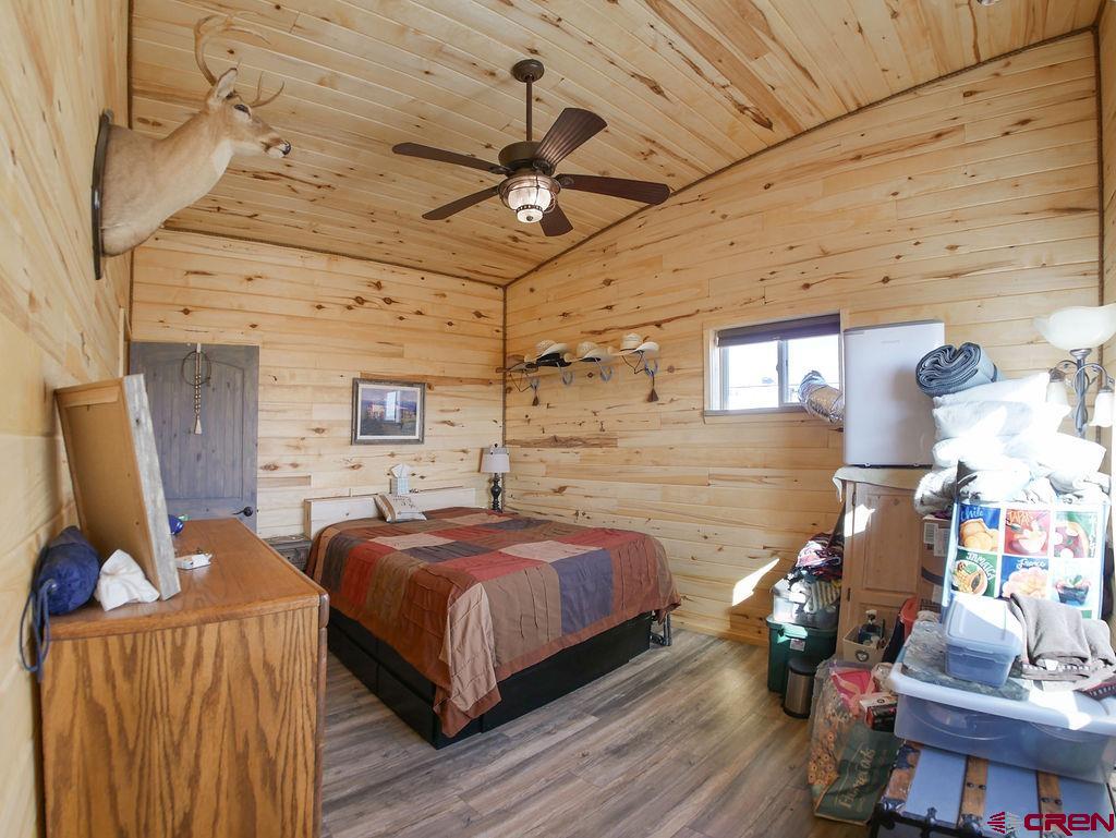 29200 Rd T.5 Dolores, CO 81323 - Photo 23 of 27 a bedroom with a bed and wooden floor