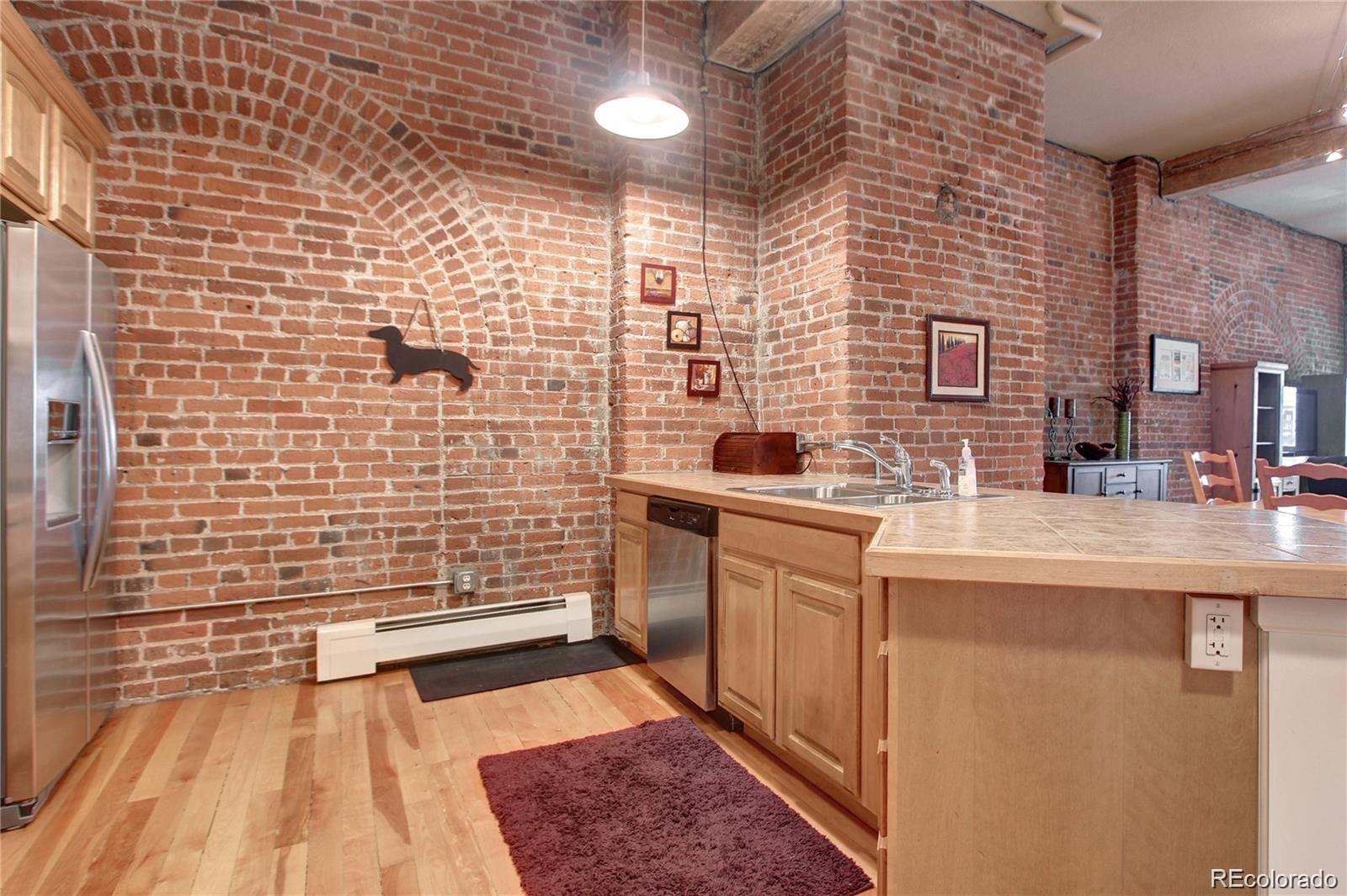 2560 Blake Street, Unit 203 Denver, CO 80205 - Photo 11 of 23 a bathroom with a sink a toilet a mirror and shower