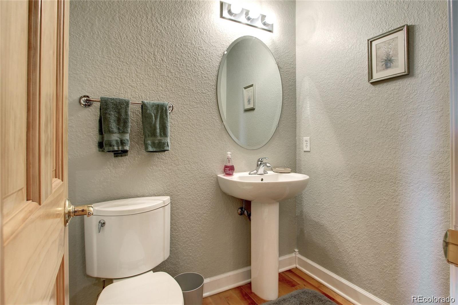 2560 Blake Street, Unit 203 Denver, CO 80205 - Photo 15 of 23 a bathroom with a toilet sink and mirror