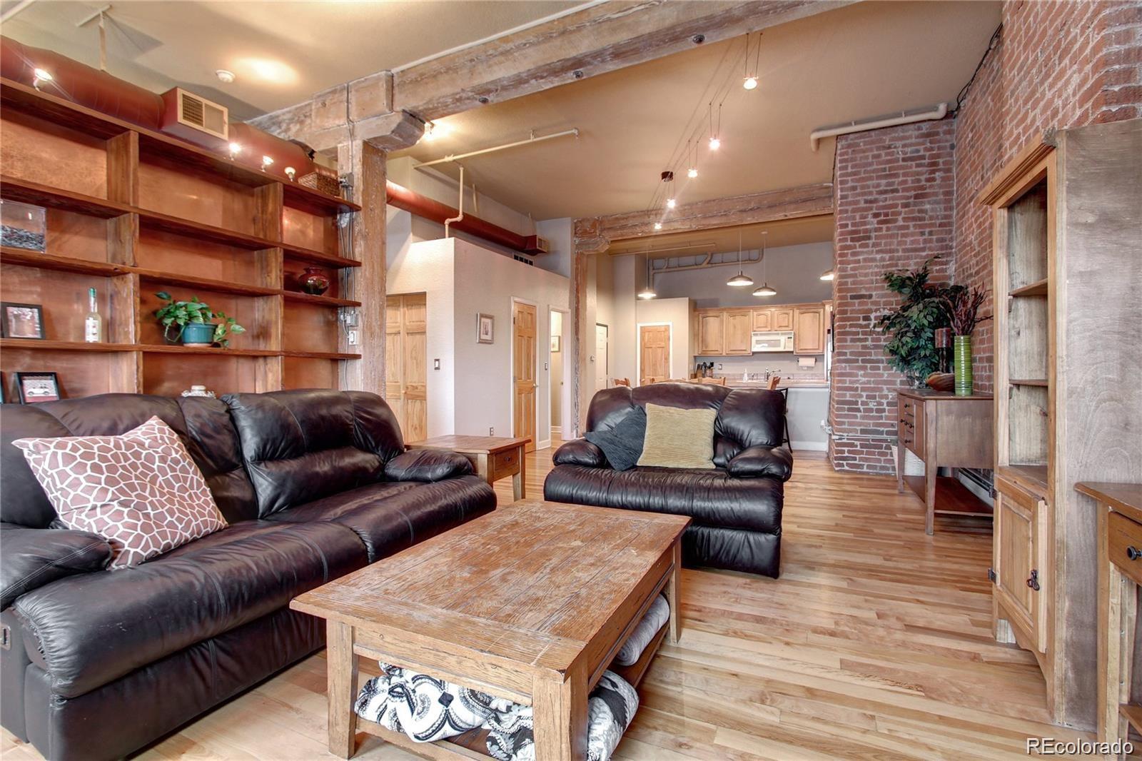 2560 Blake Street, Unit 203 Denver, CO 80205 - Photo 3 of 23 a living room with furniture and a wooden floor