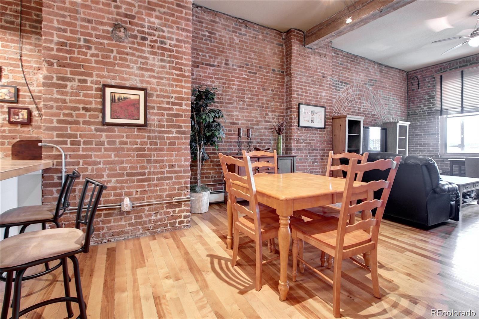 2560 Blake Street, Unit 203 Denver, CO 80205 - Photo 5 of 23 a dining room with furniture and wooden floor