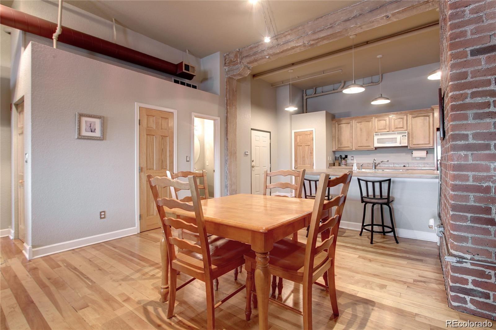 2560 Blake Street, Unit 203 Denver, CO 80205 - Photo 7 of 23 a dining room with furniture and wooden floor