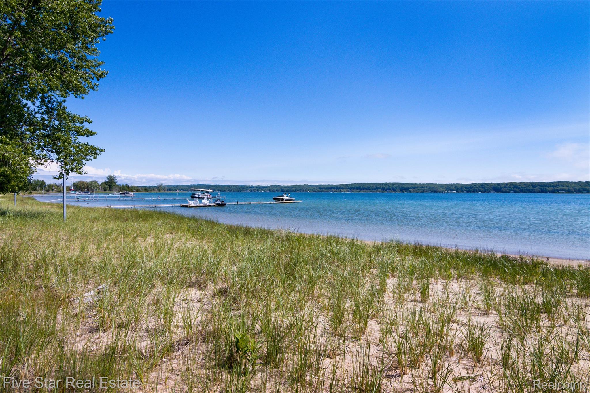 2588 Lakeview Road Onekama, MI 49675 - Photo 6 of 32 Sandy beach with natural grasses and shoreline access