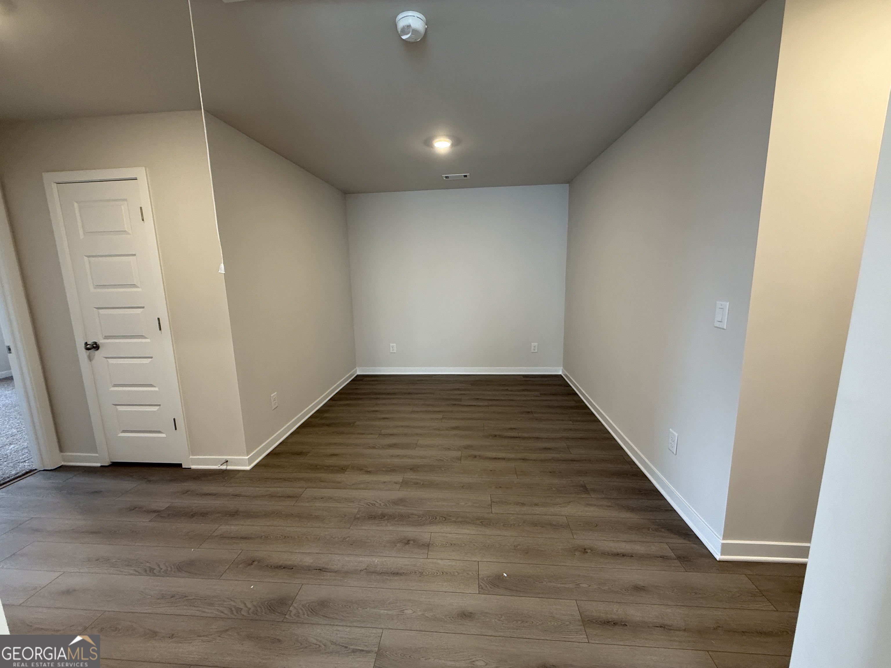 177 Depot Landing Road, Unit 26A Auburn, GA 30011 - Photo 13 of 41 a view of an empty room with wooden floor and closet