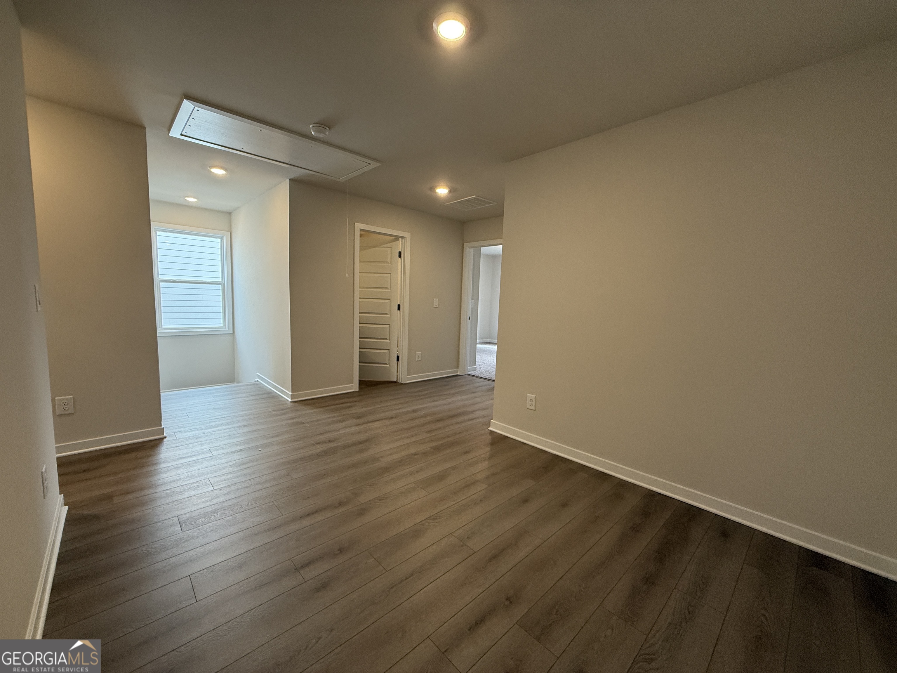 177 Depot Landing Road, Unit 26A Auburn, GA 30011 - Photo 14 of 41 a view of an empty room with wooden floor and closet