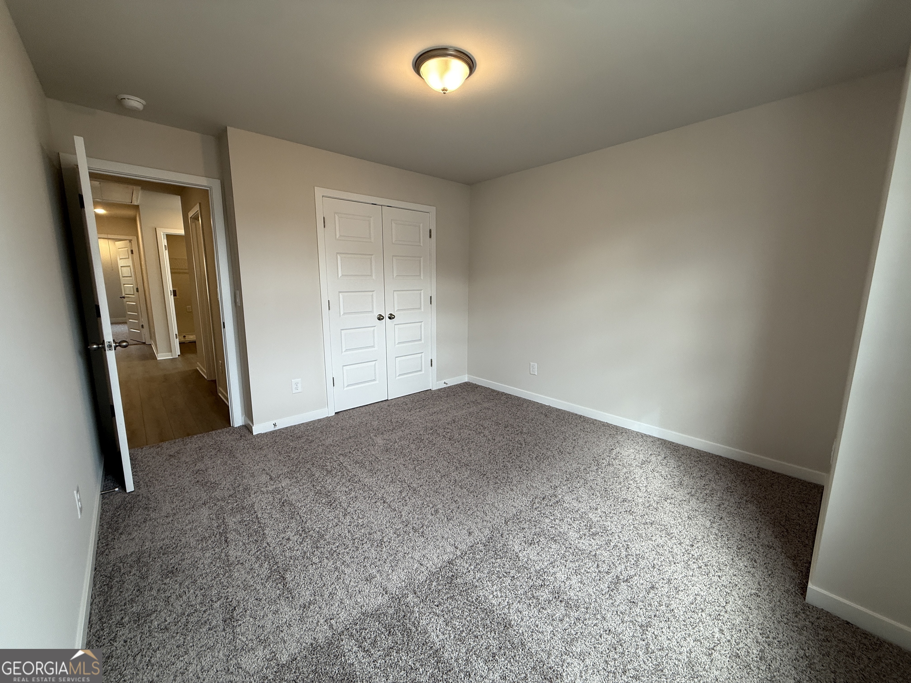 177 Depot Landing Road, Unit 26A Auburn, GA 30011 - Photo 16 of 41 an empty room with closet and mirror