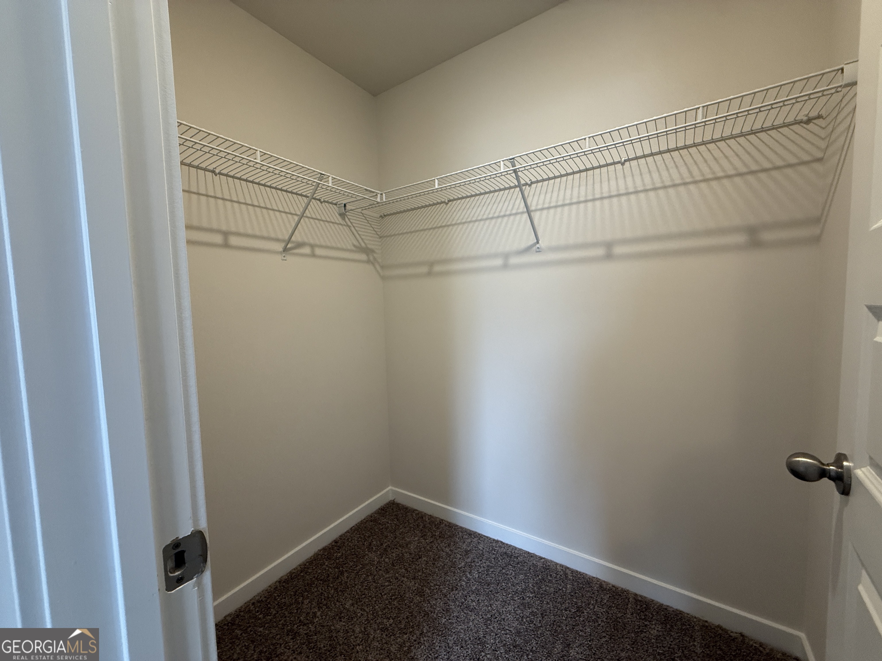177 Depot Landing Road, Unit 26A Auburn, GA 30011 - Photo 21 of 41 a view of a room with racks on the wall