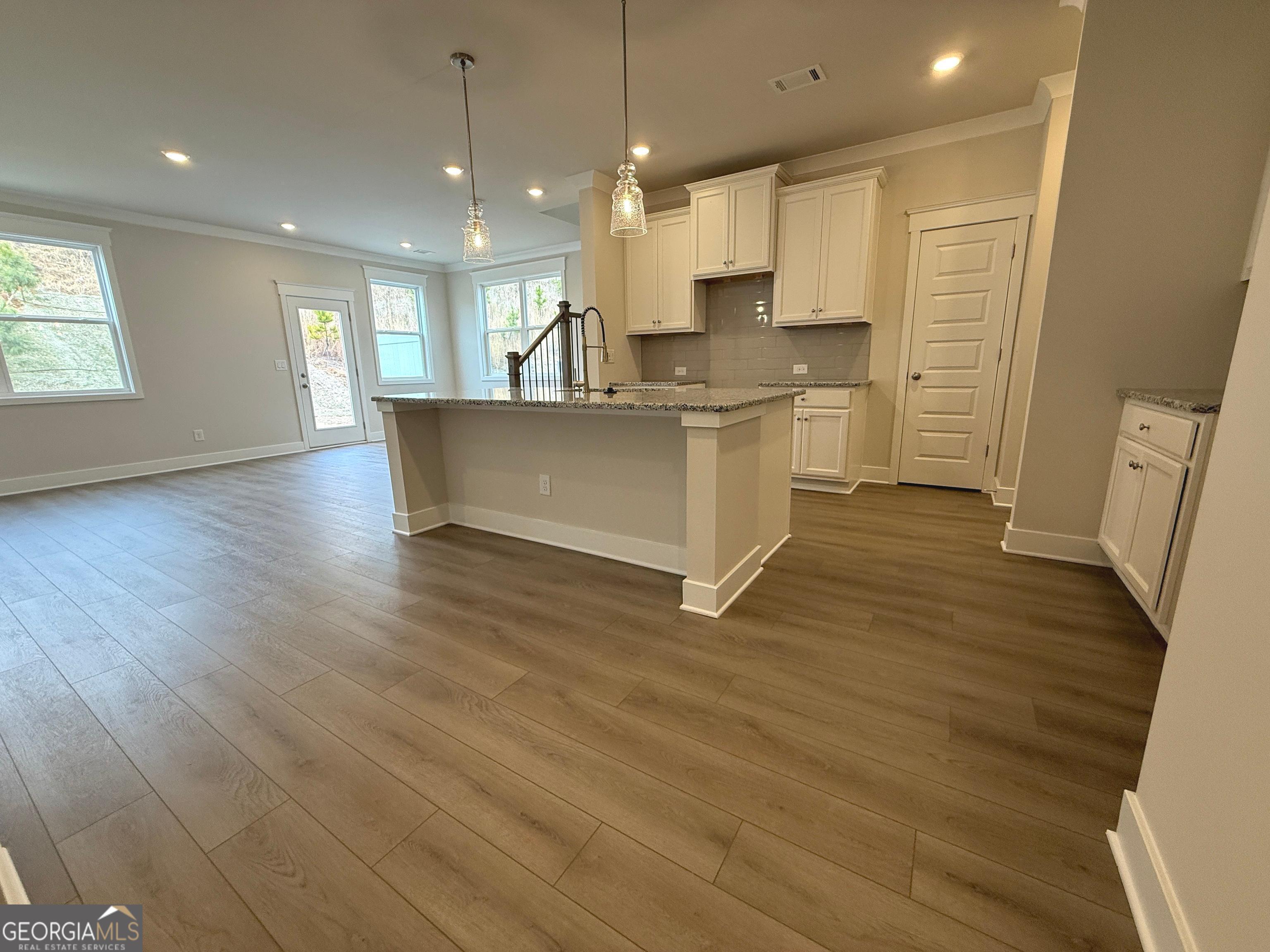 177 Depot Landing Road, Unit 26A Auburn, GA 30011 - Photo 3 of 41 a view of kitchen with cabinets microwave and wooden floor