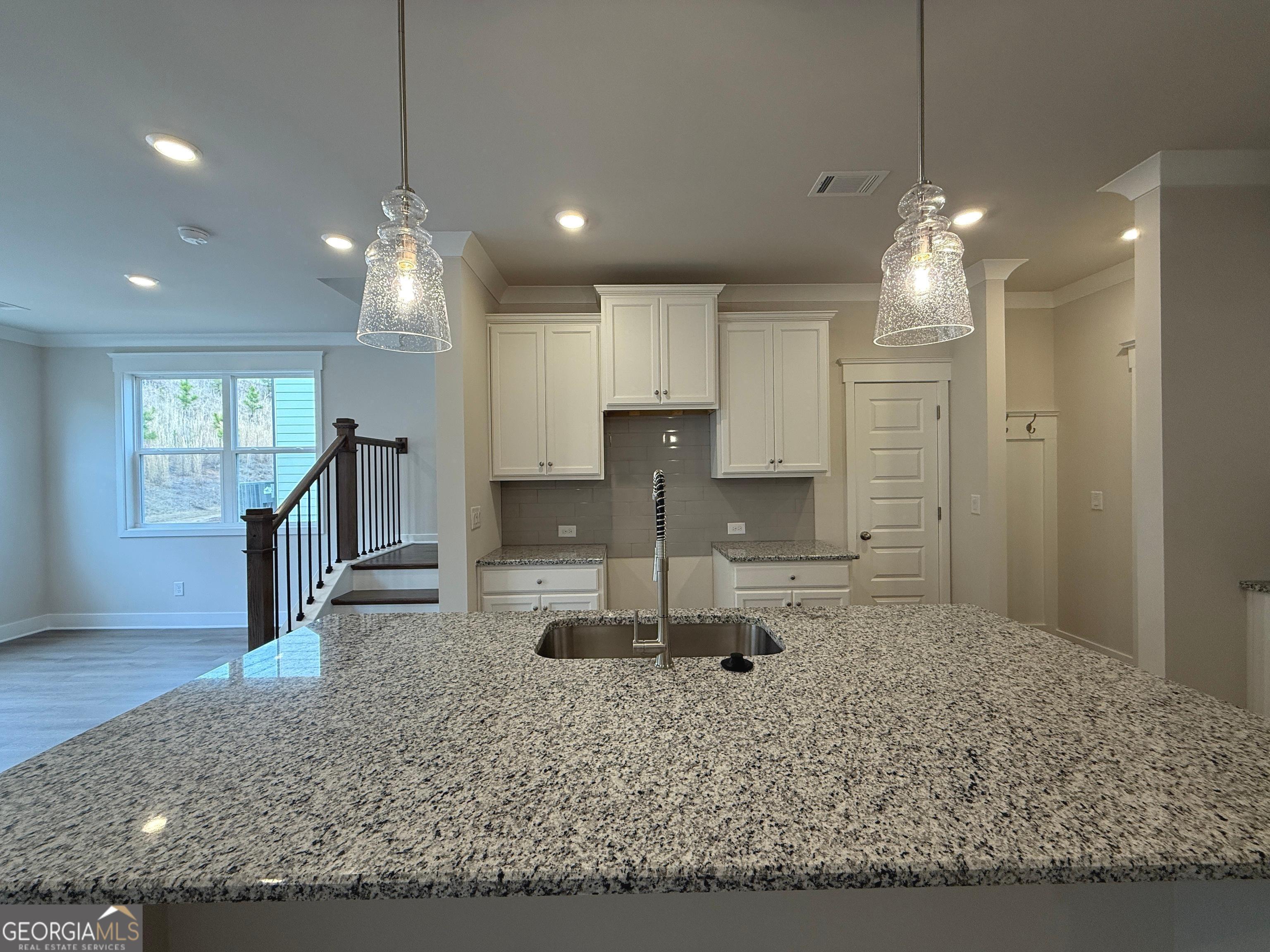 177 Depot Landing Road, Unit 26A Auburn, GA 30011 - Photo 4 of 41 a view of a kitchen with kitchen island stainless steel appliances granite countertop sink and wooden floor