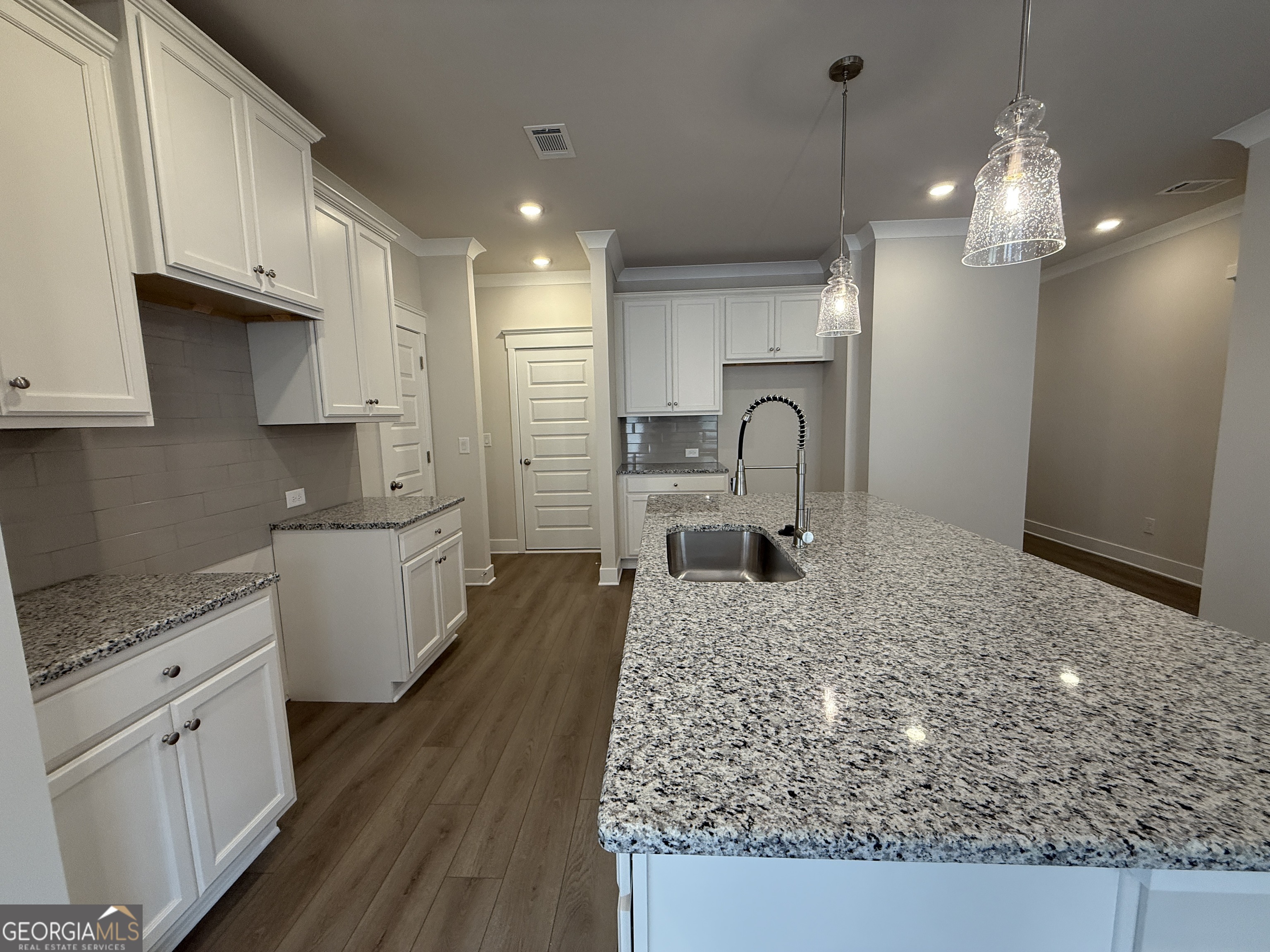 177 Depot Landing Road, Unit 26A Auburn, GA 30011 - Photo 5 of 41 a large kitchen with kitchen island a sink stainless steel appliances and cabinets