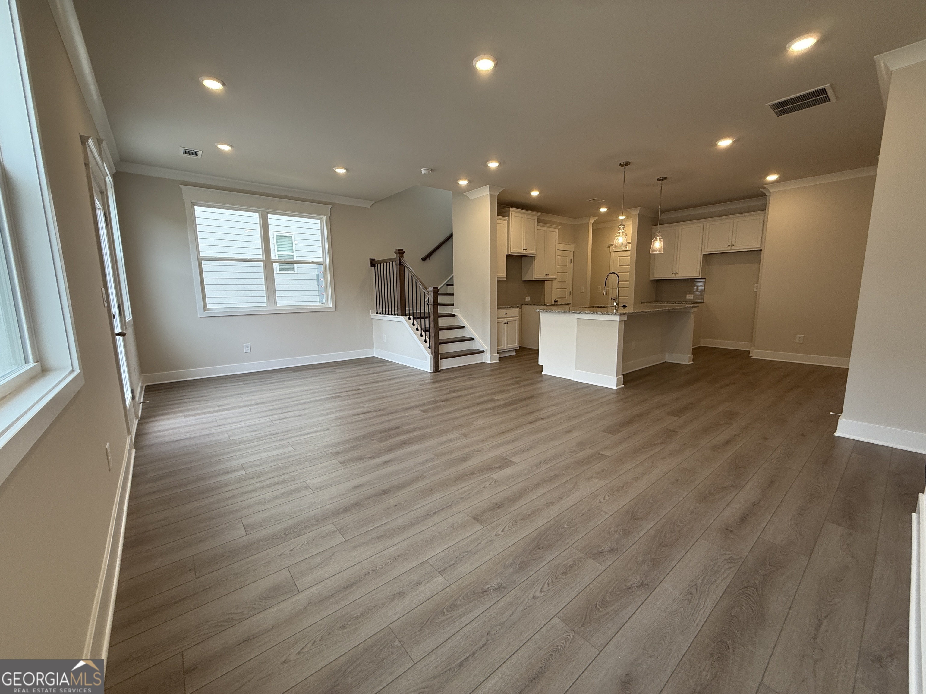 177 Depot Landing Road, Unit 26A Auburn, GA 30011 - Photo 9 of 41 a view of an empty room with wooden floor and a window