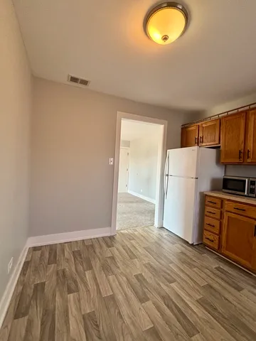 a view of a kitchen with a sink and a refrigerator