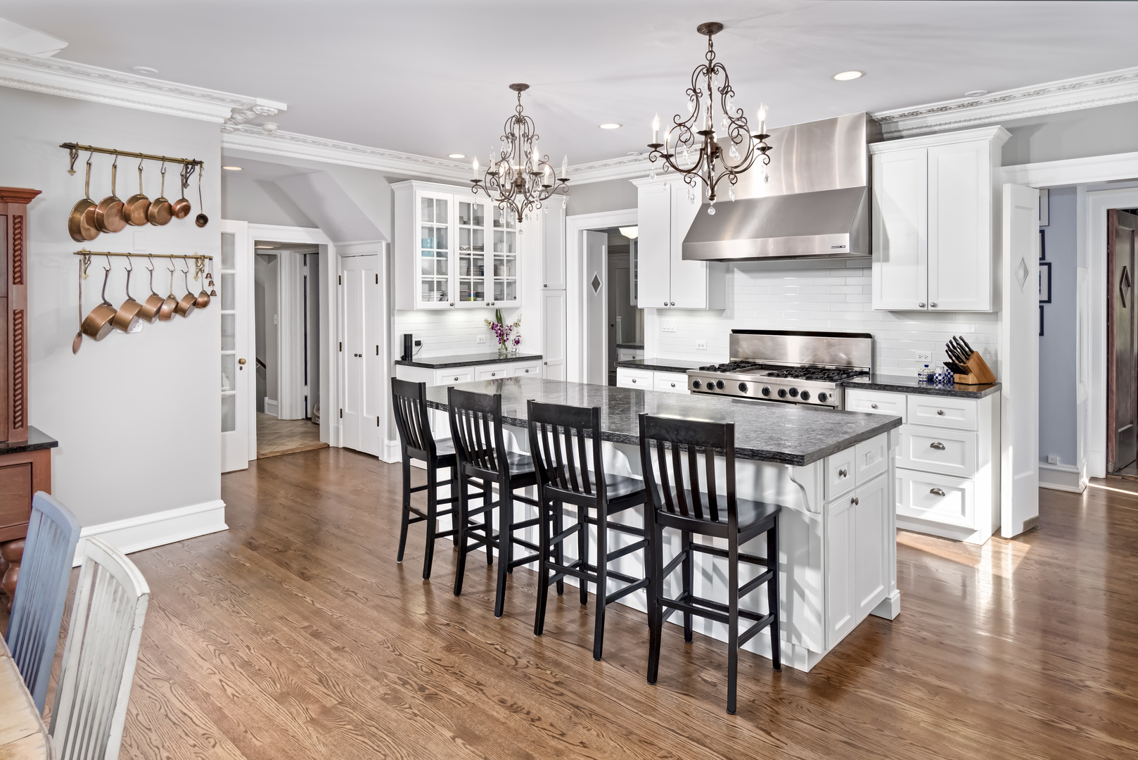 1111 Sheridan Road Wilmette, IL 60091 - Photo 19 of 76 a kitchen with stainless steel appliances a dining table chairs stove and refrigerator