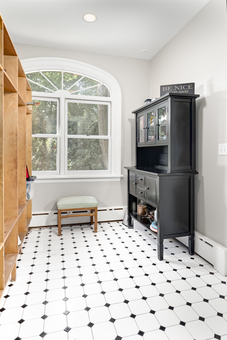 1111 Sheridan Road Wilmette, IL 60091 - Photo 27 of 76 a living room with a couch and a flat screen tv