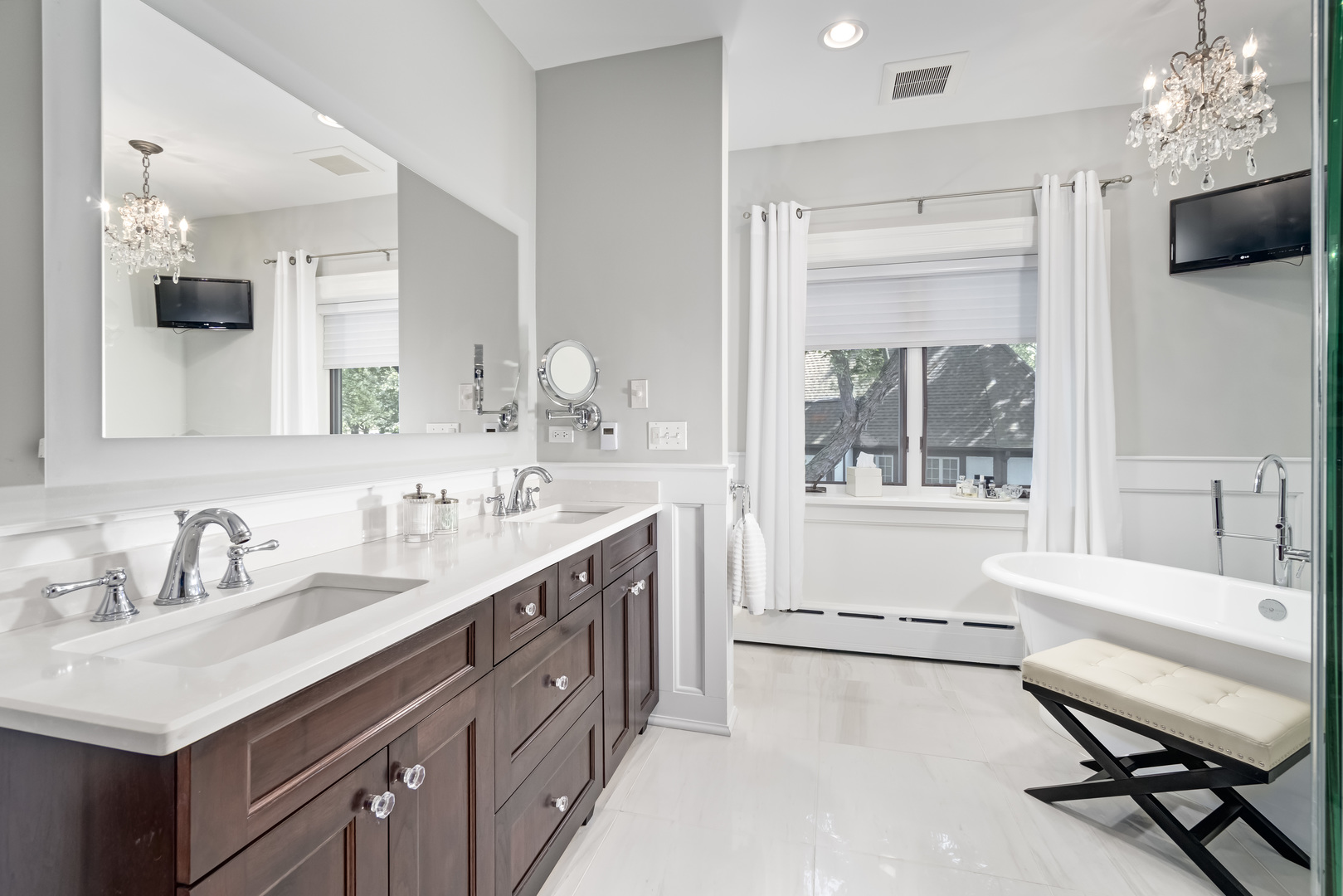 1111 Sheridan Road Wilmette, IL 60091 - Photo 40 of 76 a bathroom with a sink double vanity a mirror and a bathtub