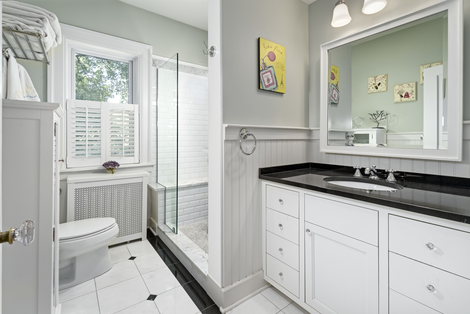 1111 Sheridan Road Wilmette, IL 60091 - Photo 51 of 76 a bathroom with a sink a toilet a mirror and shower