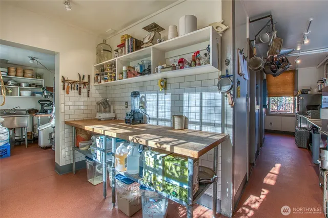 a kitchen with stainless steel appliances kitchen island granite countertop a sink and cabinets