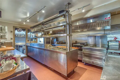 a kitchen with stainless steel appliances granite countertop a stove and a sink