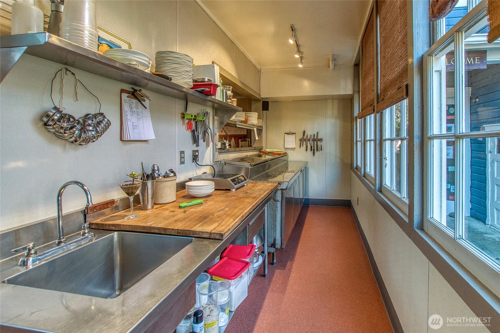 326 Olga Road Orcas Island, WA 98245 - Photo 15 of 39 a kitchen with stainless steel appliances granite countertop a sink and a wooden floor
