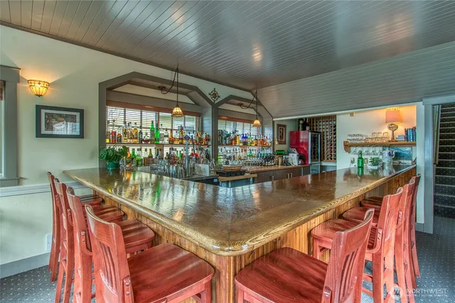 a living room with lots of furniture and kitchen view