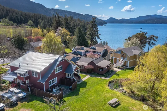 an aerial view of a house with swimming pool and lake view