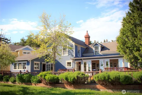 a front view of a residential houses with yard and green space