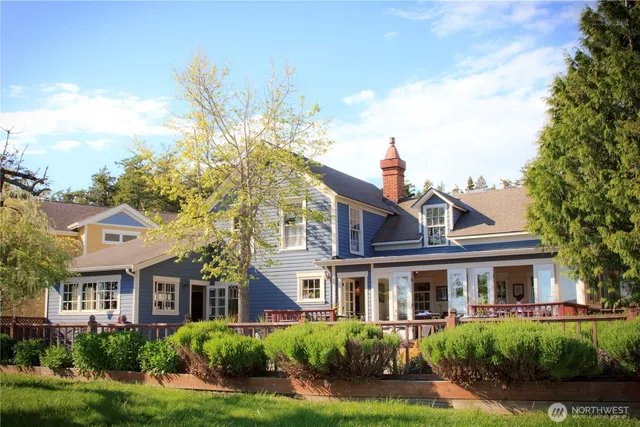 a front view of a residential houses with yard and green space
