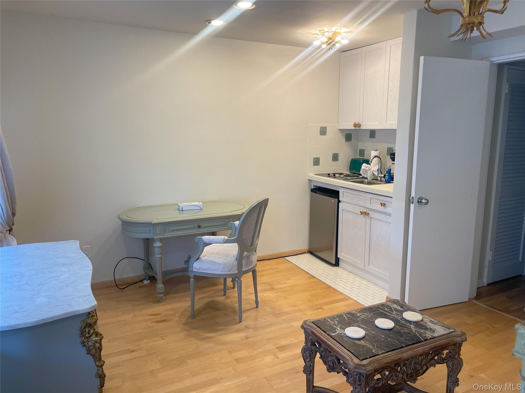 379 Bluff Road, Unit 115 Amagansett, NY 11930 - Photo 11 of 28 a workspace with furniture and wooden floor