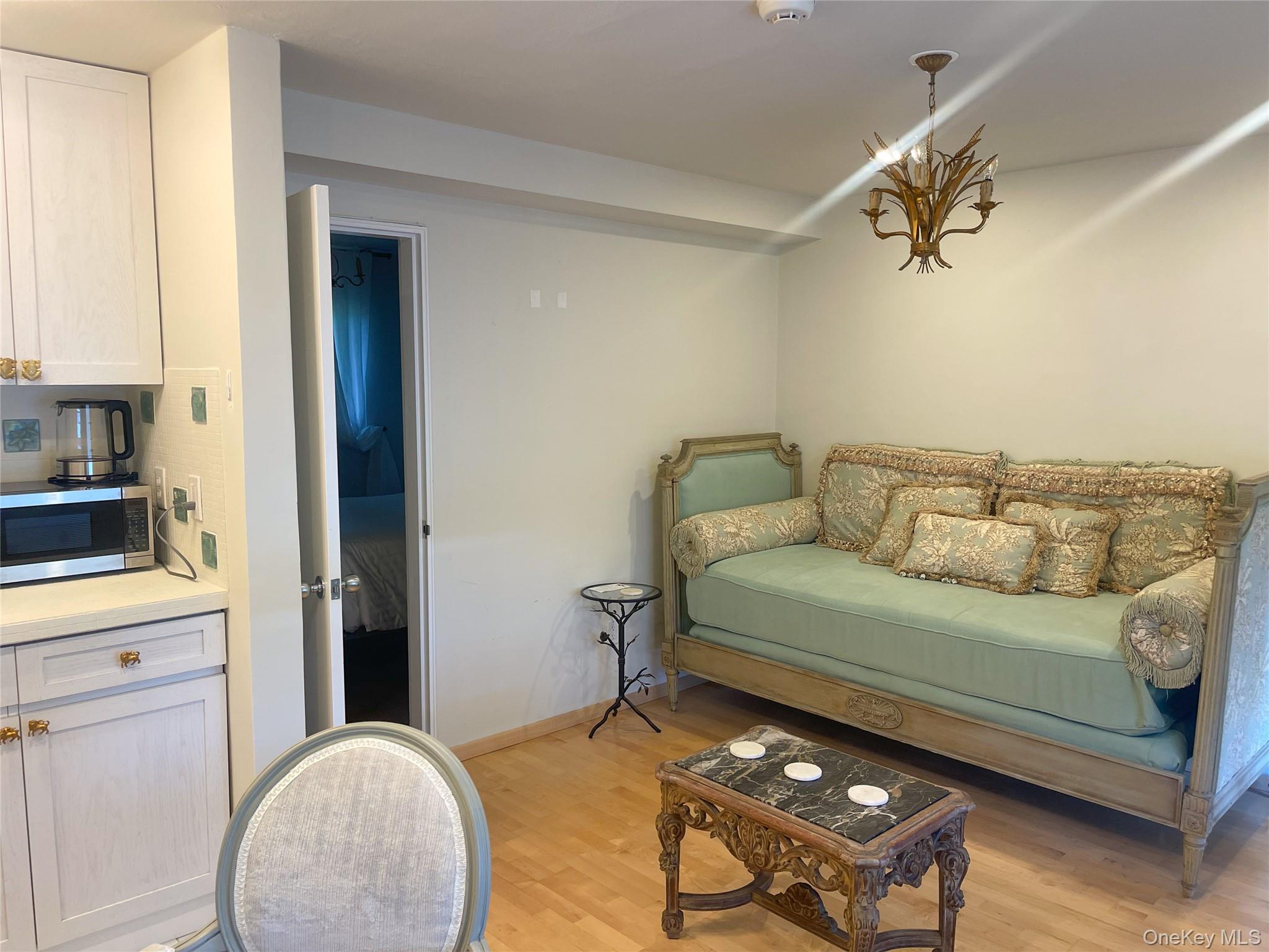379 Bluff Road, Unit 115 Amagansett, NY 11930 - Photo 12 of 28 a living room with furniture and a flat screen tv