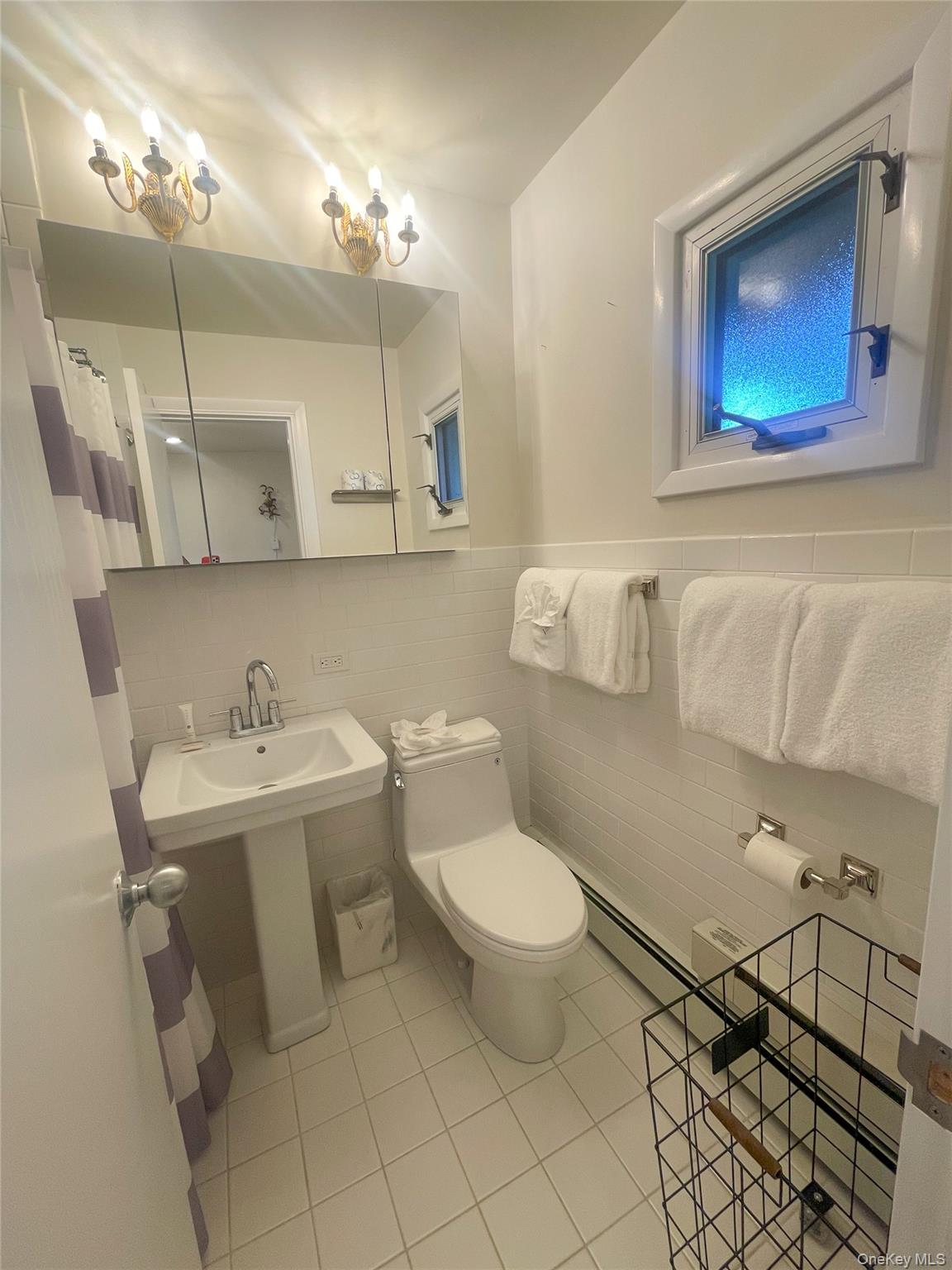 379 Bluff Road, Unit 115 Amagansett, NY 11930 - Photo 18 of 28 a bathroom with a sink toilet and mirror