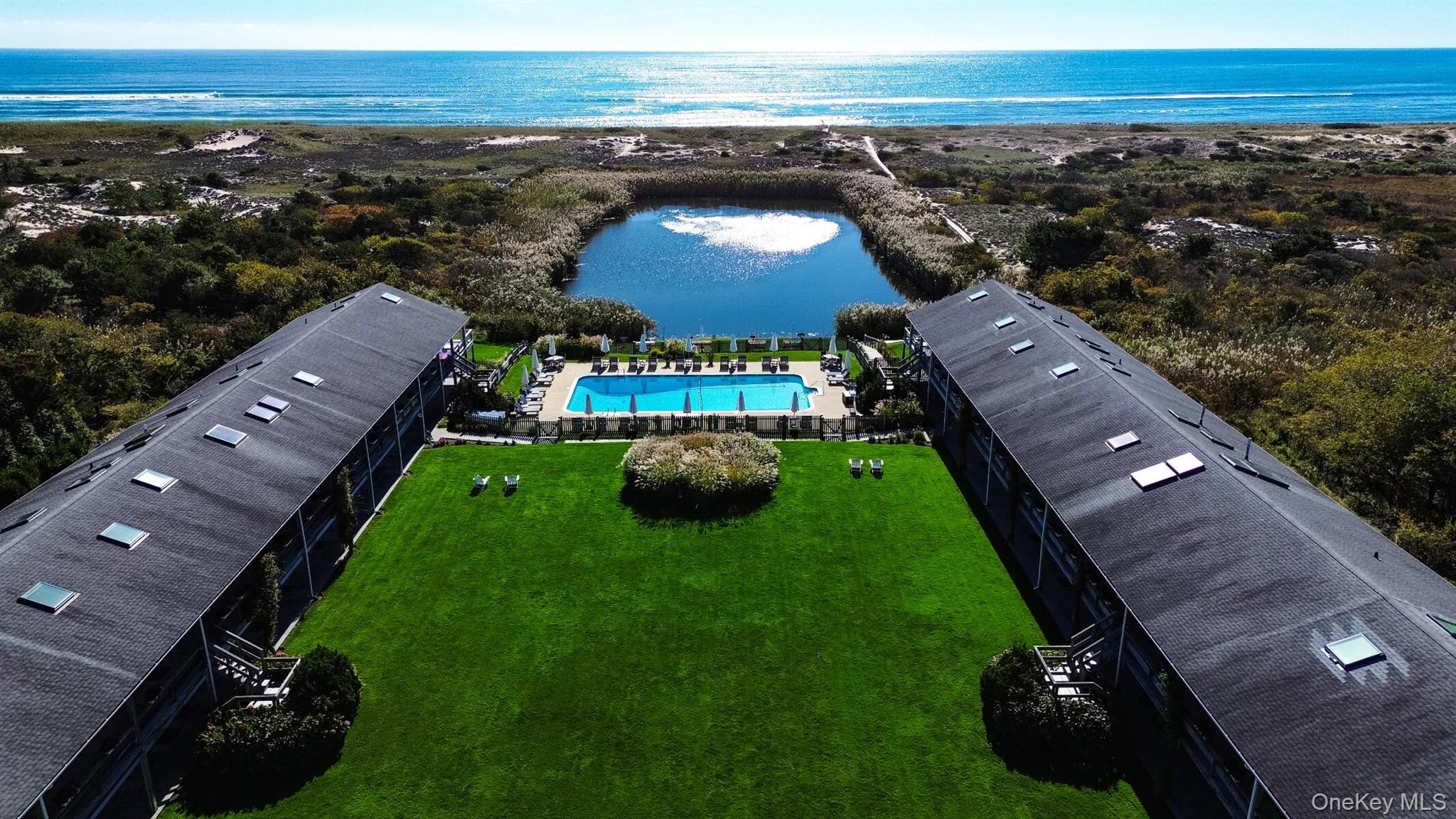 379 Bluff Road, Unit 115 Amagansett, NY 11930 - Photo 2 of 28 an aerial view of a house with a yard