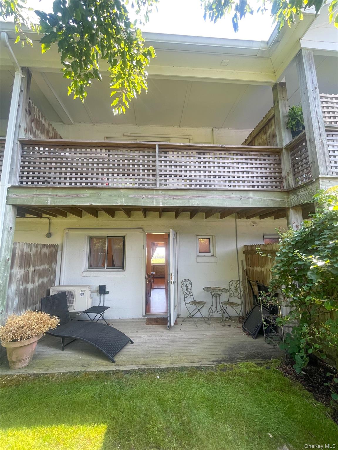 379 Bluff Road, Unit 115 Amagansett, NY 11930 - Photo 23 of 28 a front view of a house with swimming pool