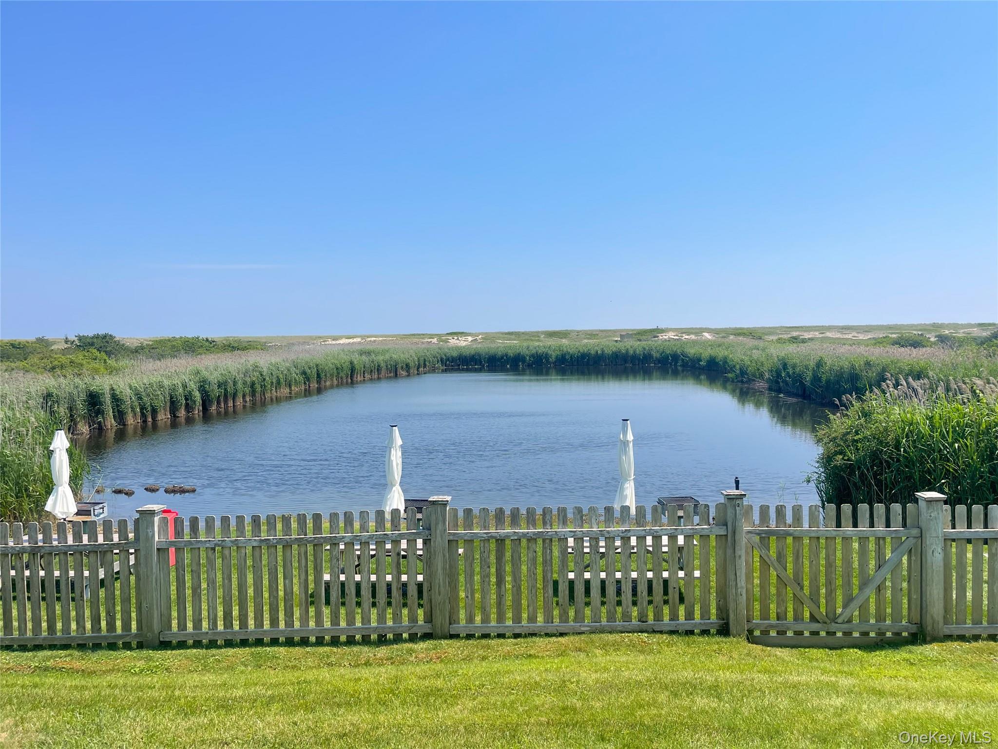 379 Bluff Road, Unit 115 Amagansett, NY 11930 - Photo 6 of 28 a view of a wooden bridge near a lake