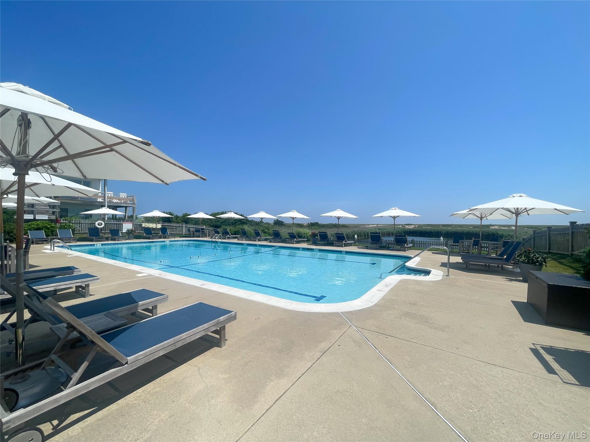 379 Bluff Road, Unit 115 Amagansett, NY 11930 - Photo 7 of 28 a view of swimming pool with outdoor seating and yard
