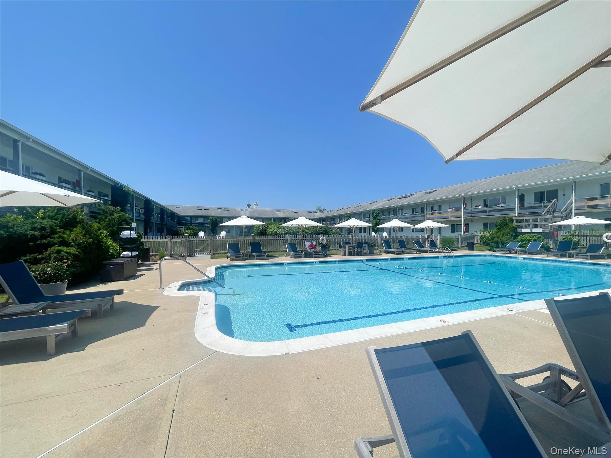379 Bluff Road, Unit 115 Amagansett, NY 11930 - Photo 8 of 28 a view of swimming pool with seating area and furniture