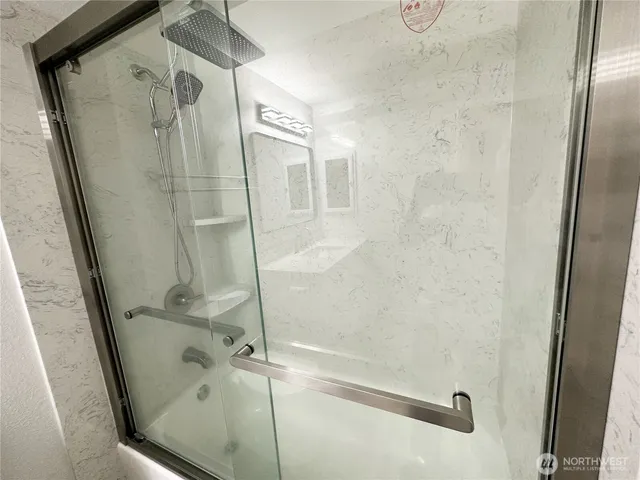 a bathroom with a glass door shower