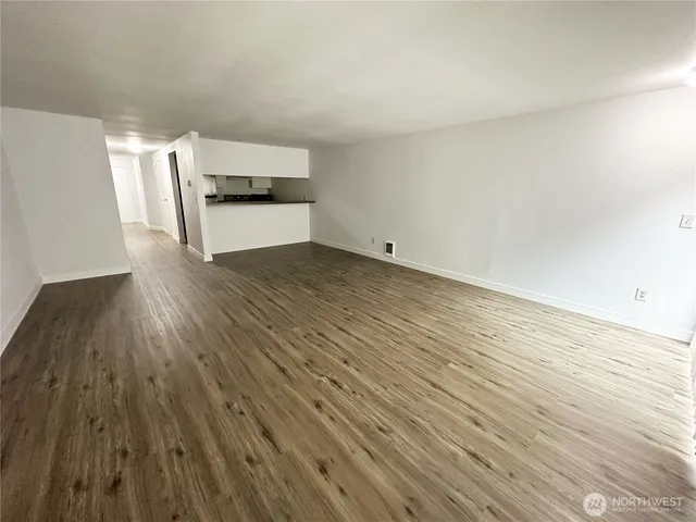 a view of a kitchen with wooden floor