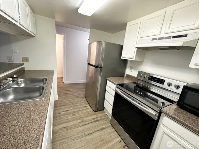 a kitchen with a stove and a refrigerator