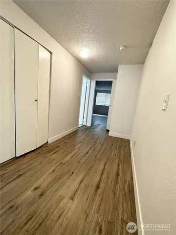 a view of empty room with wooden floor