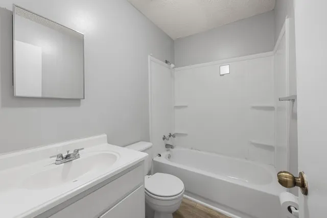 a bath room with a toilet a sink and a bath tub