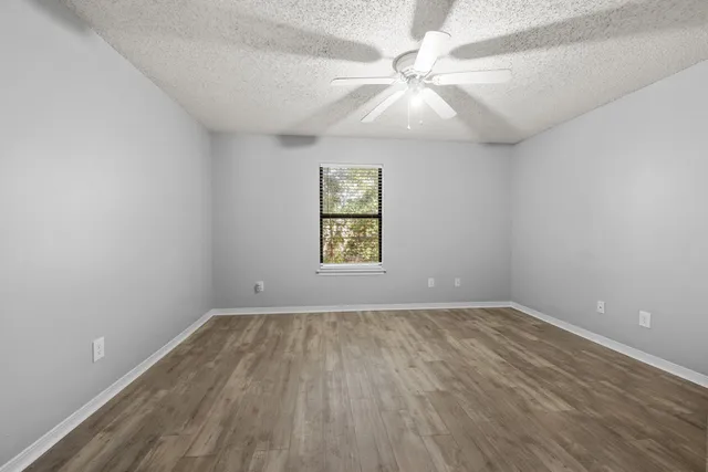 wooden floor in an empty room with a window