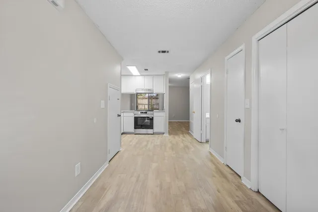 a view of a kitchen with a sink and wooden floor